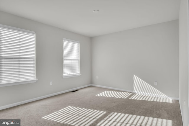 unfurnished room with light carpet