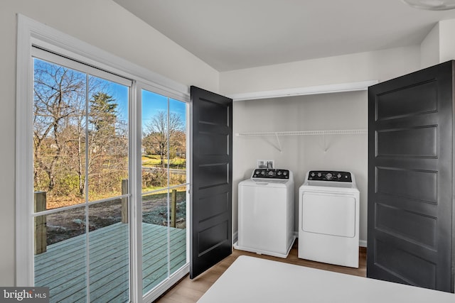 laundry area with hardwood / wood-style flooring and washer and dryer