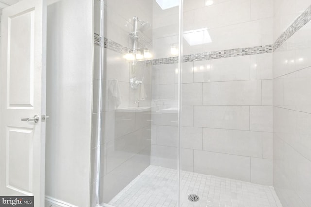 bathroom with a shower with door