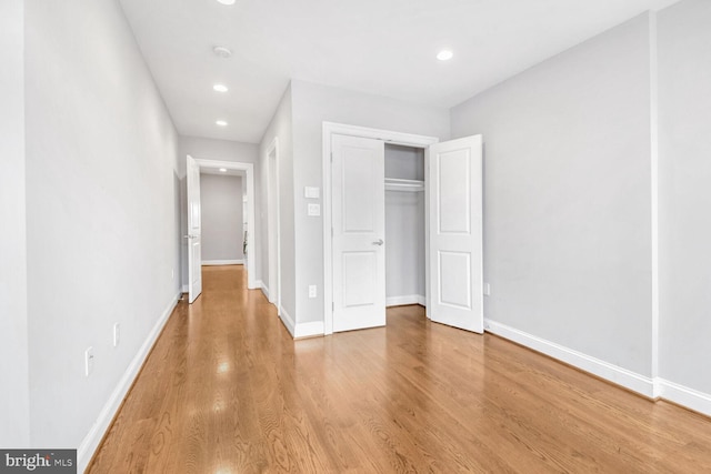 unfurnished bedroom with a closet and wood-type flooring