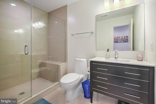 bathroom featuring a shower with shower door, toilet, and vanity