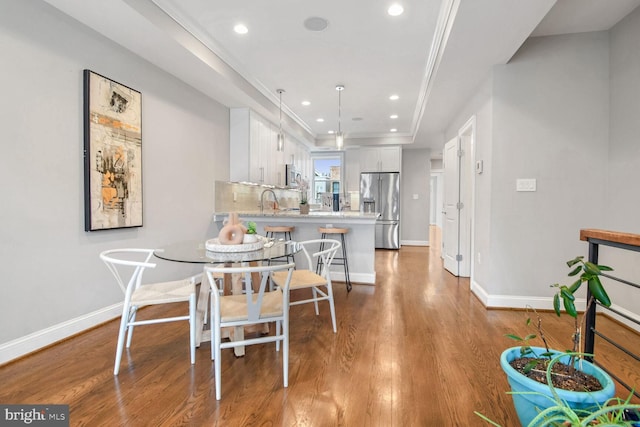 dining room featuring wood-type flooring and ornamental molding