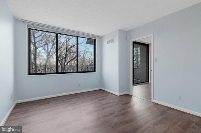 empty room with dark hardwood / wood-style floors