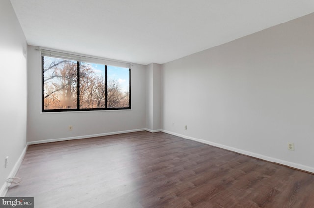 spare room featuring dark wood-type flooring