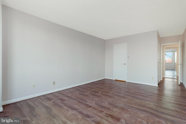 spare room featuring dark hardwood / wood-style floors