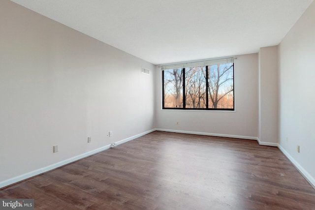 spare room featuring dark hardwood / wood-style floors