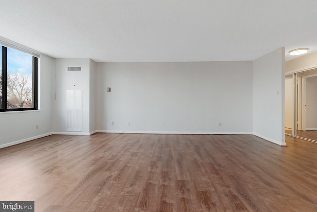 empty room with wood-type flooring