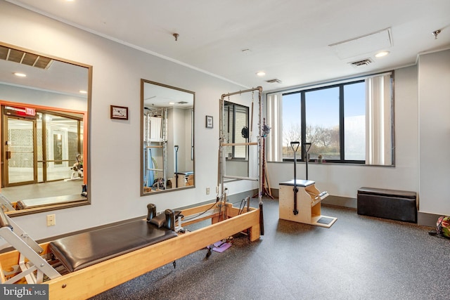 workout room with ornamental molding