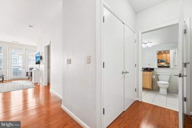 corridor with light hardwood / wood-style flooring