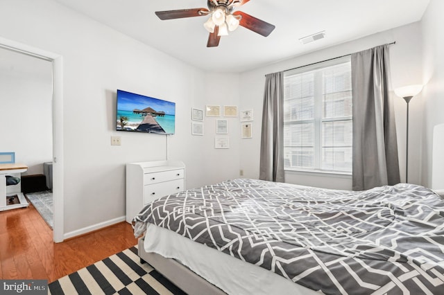 bedroom with wood-type flooring and ceiling fan