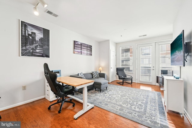 office featuring track lighting and light hardwood / wood-style floors