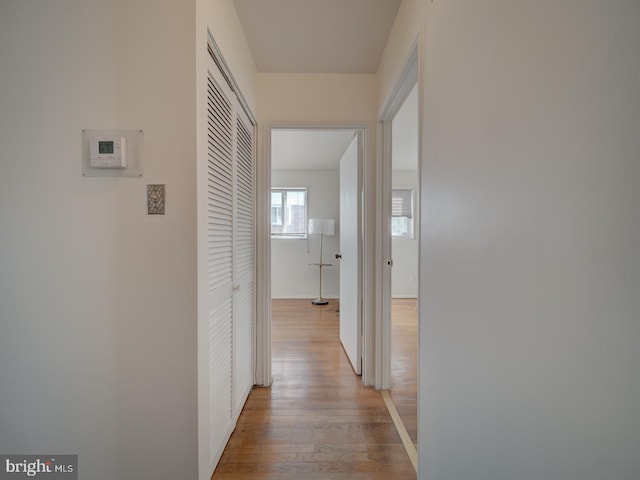 hallway with light hardwood / wood-style floors