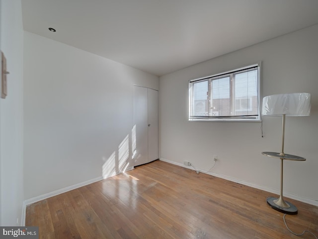 empty room with light hardwood / wood-style flooring