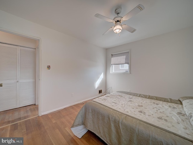 bedroom featuring hardwood / wood-style flooring, a closet, and ceiling fan