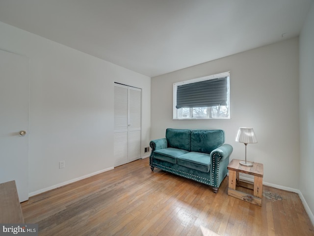 sitting room with wood-type flooring