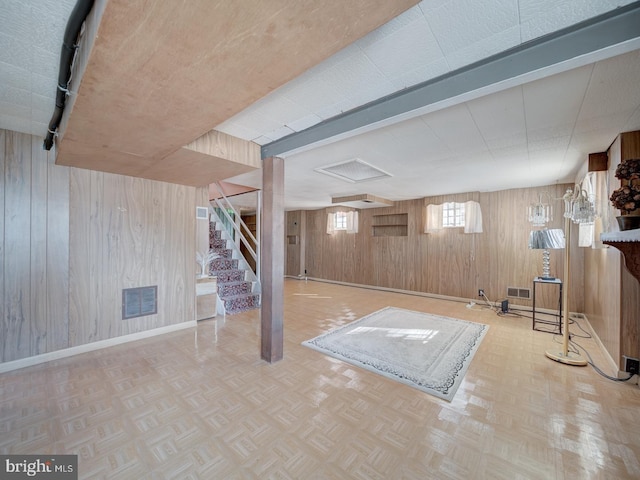 basement featuring wooden walls and parquet flooring