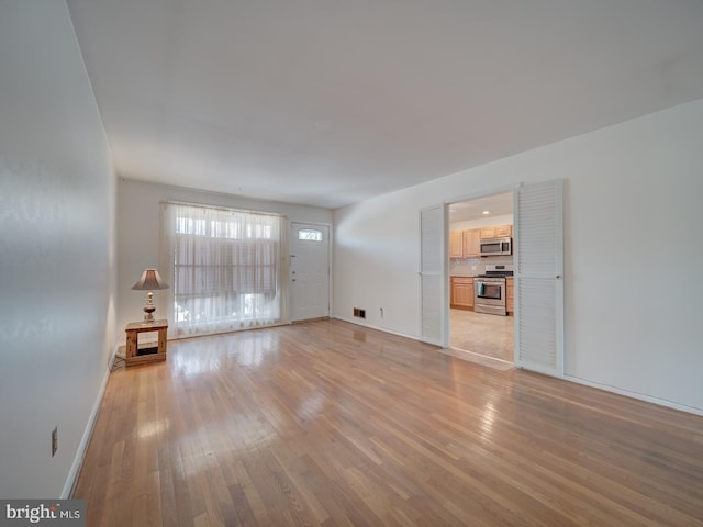 unfurnished living room with light wood-type flooring