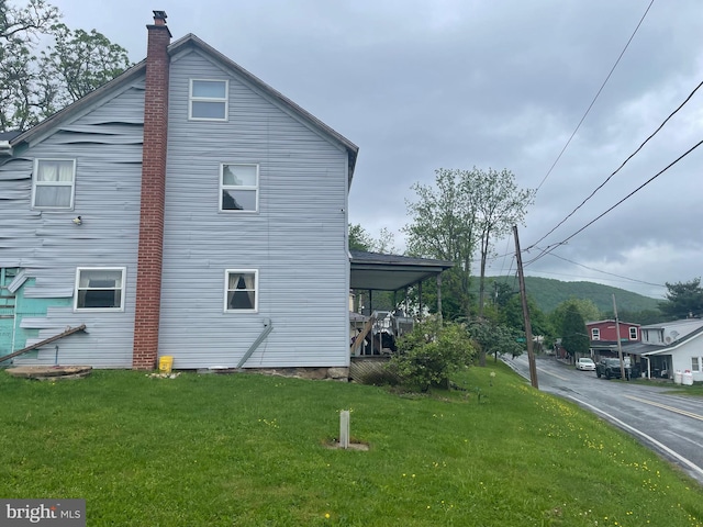 view of side of home featuring a lawn