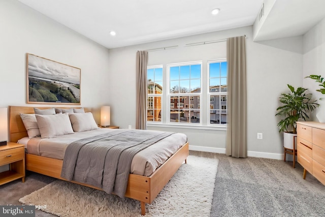 bedroom with dark colored carpet