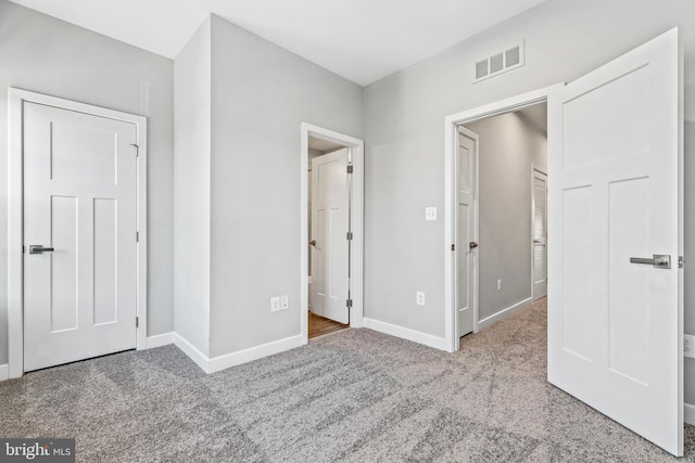 unfurnished bedroom with light colored carpet