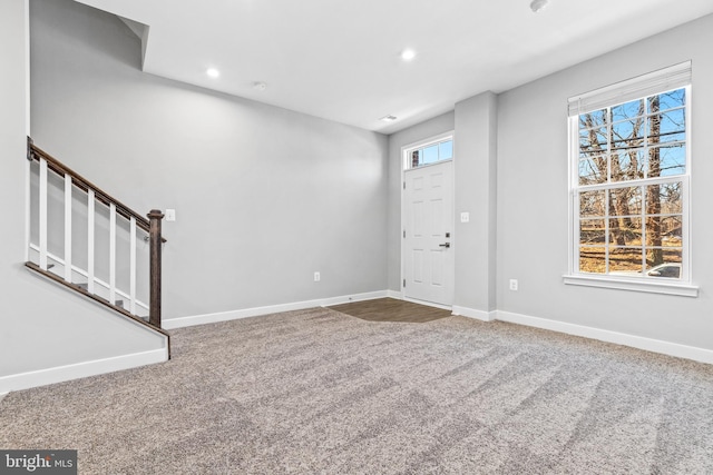 entrance foyer with carpet flooring