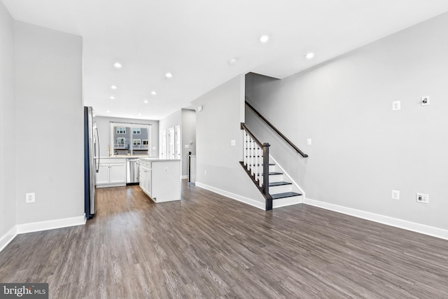 unfurnished living room with dark wood-type flooring