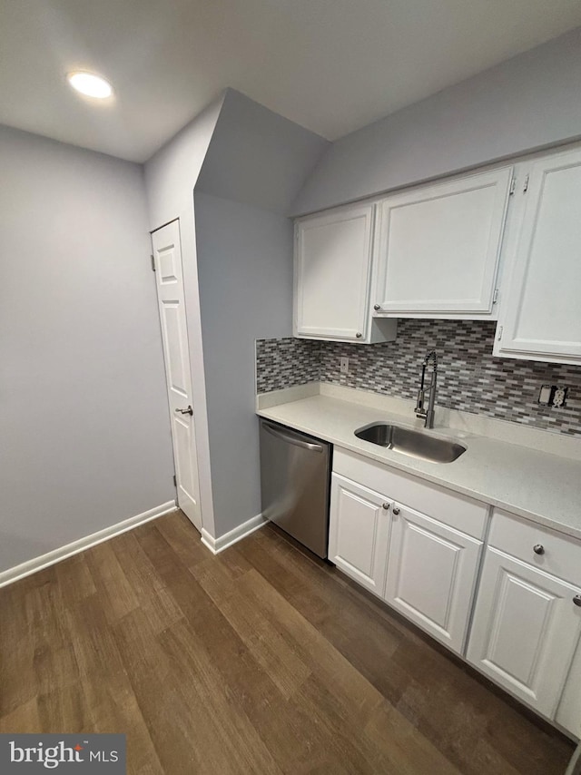 kitchen featuring tasteful backsplash, stainless steel dishwasher, white cabinets, sink, and dark hardwood / wood-style flooring