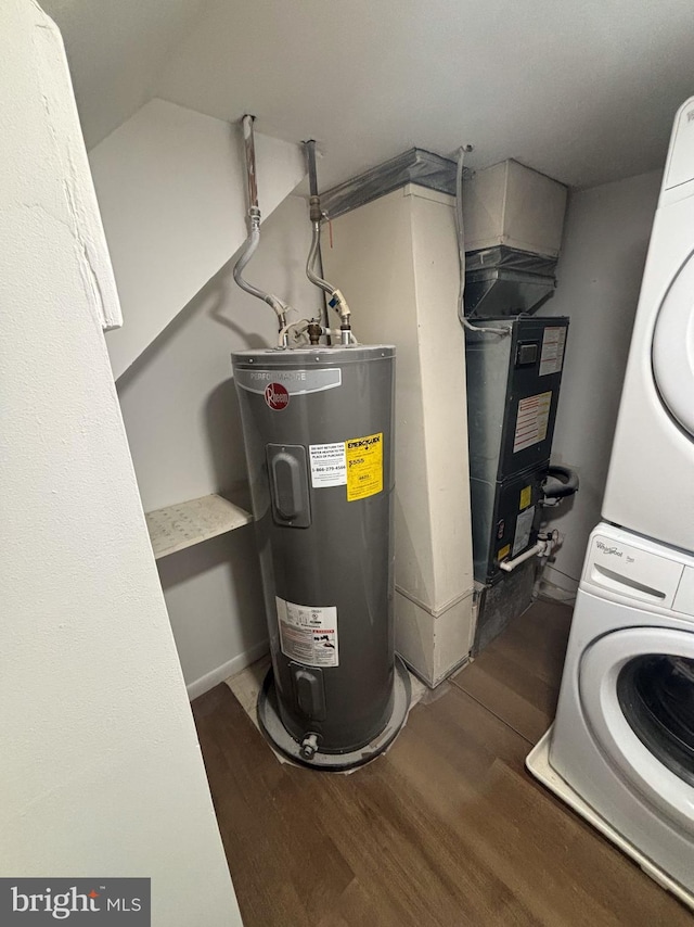 utility room featuring stacked washer / drying machine and water heater