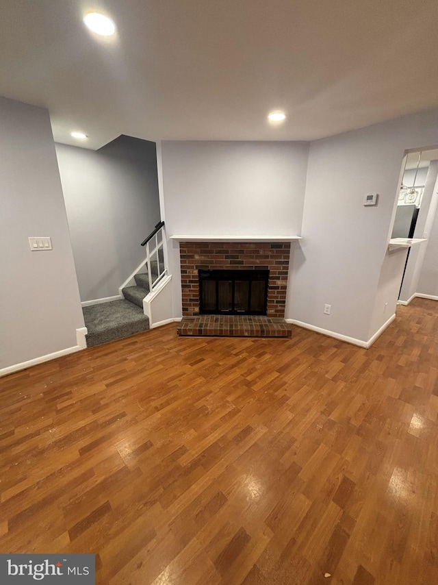 unfurnished living room with a fireplace and hardwood / wood-style flooring