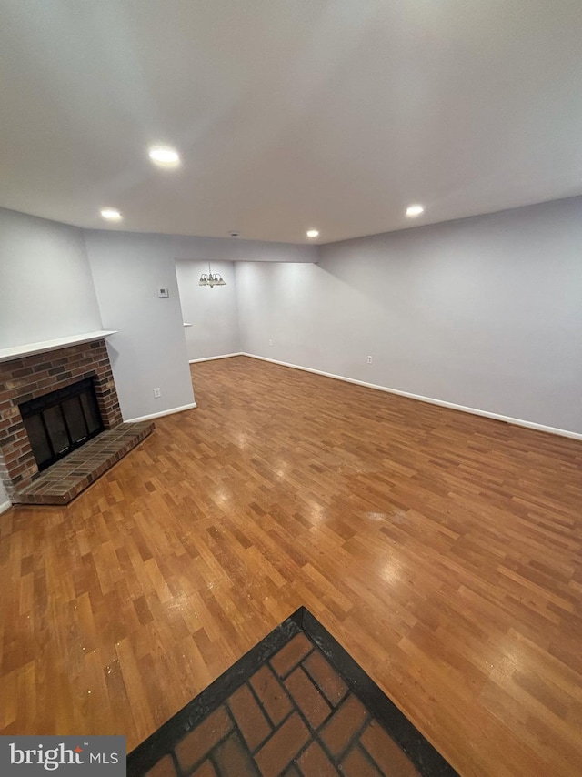 unfurnished living room with a fireplace and hardwood / wood-style floors