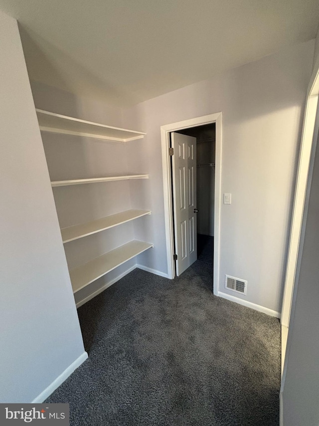 interior space featuring dark colored carpet