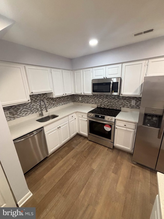 kitchen with sink, white cabinets, and appliances with stainless steel finishes