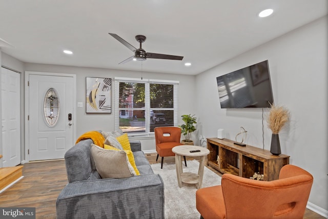 living room featuring hardwood / wood-style flooring and ceiling fan