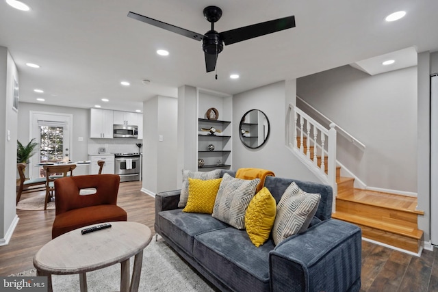 living room featuring hardwood / wood-style flooring and ceiling fan