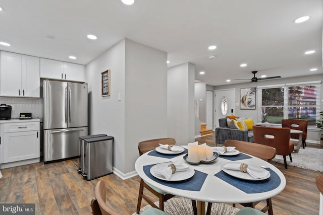 dining room with dark wood-type flooring and ceiling fan