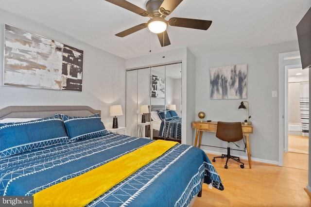 bedroom with hardwood / wood-style floors, ceiling fan, and a closet