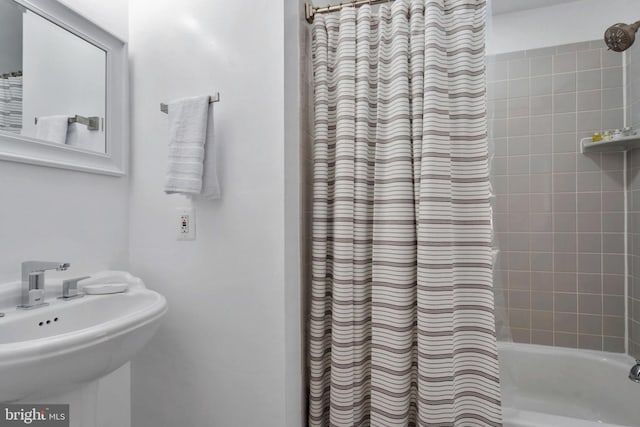 bathroom featuring sink and shower / bath combo with shower curtain