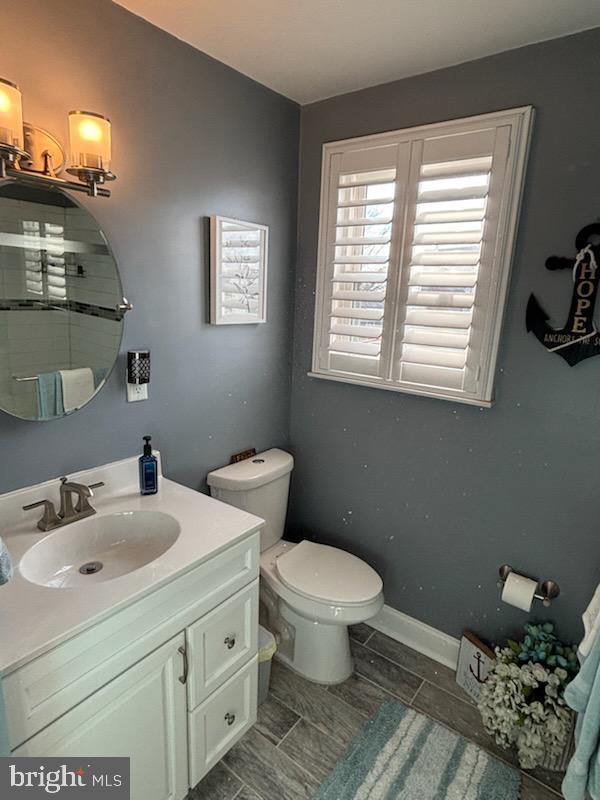 bathroom featuring vanity and toilet