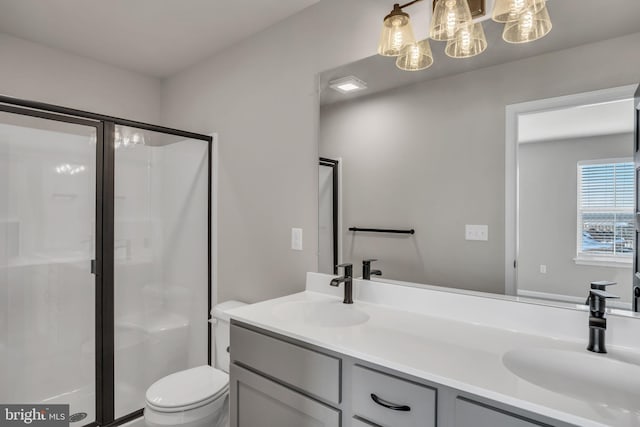 bathroom featuring vanity, toilet, and an enclosed shower