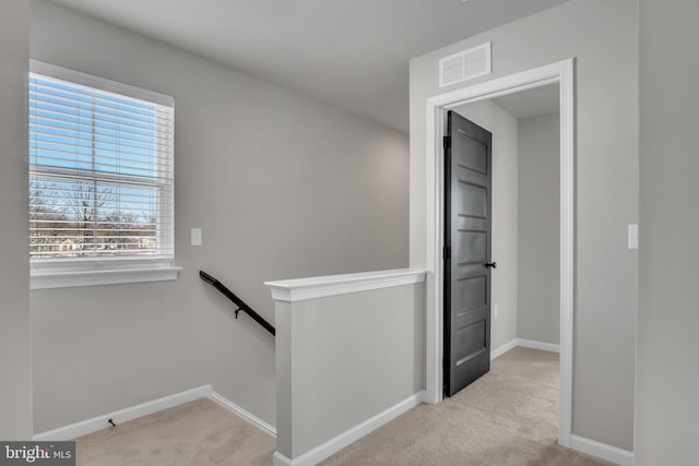 hallway with light carpet