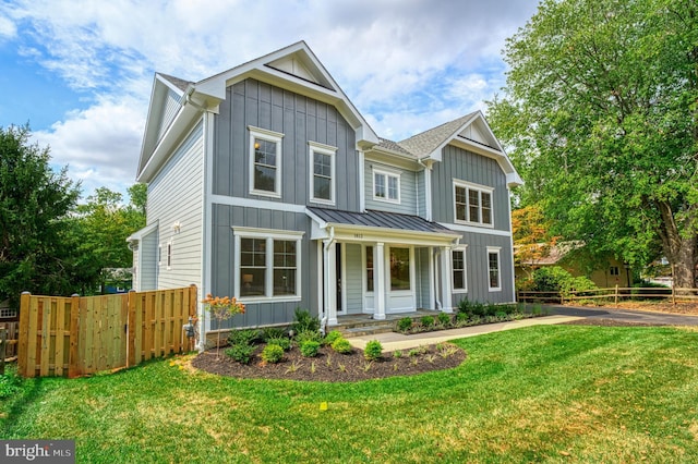 view of front of home with covered porch and a front lawn