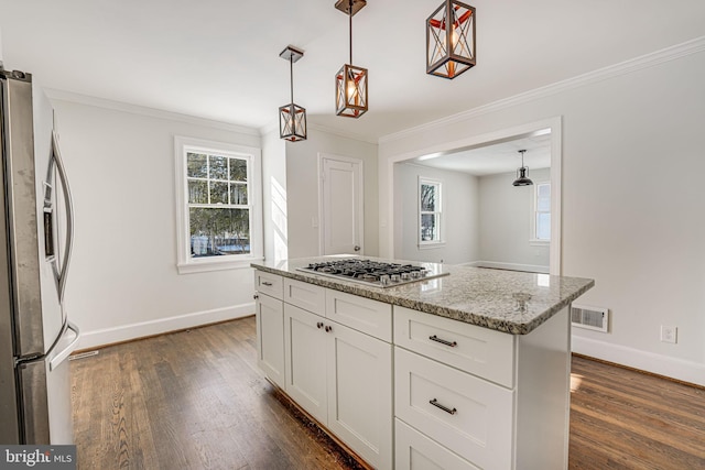 kitchen featuring white cabinetry, hanging light fixtures, stainless steel appliances, a center island, and light stone countertops