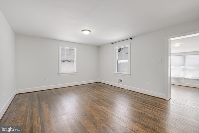 spare room with dark wood-type flooring