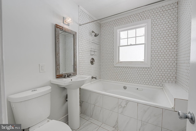 bathroom with tiled shower / bath combo, crown molding, and toilet