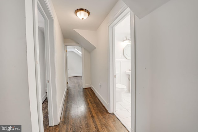 corridor with dark hardwood / wood-style flooring