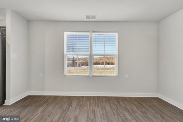 spare room featuring dark wood-type flooring