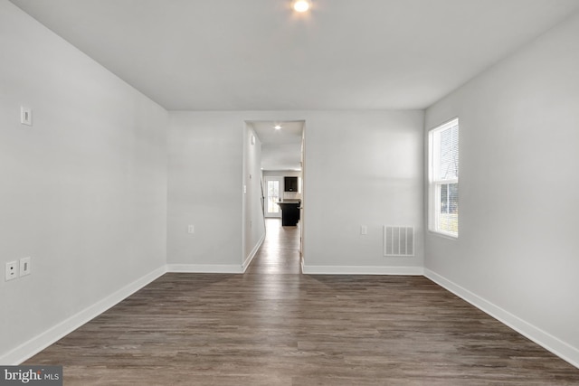 spare room with dark wood-type flooring