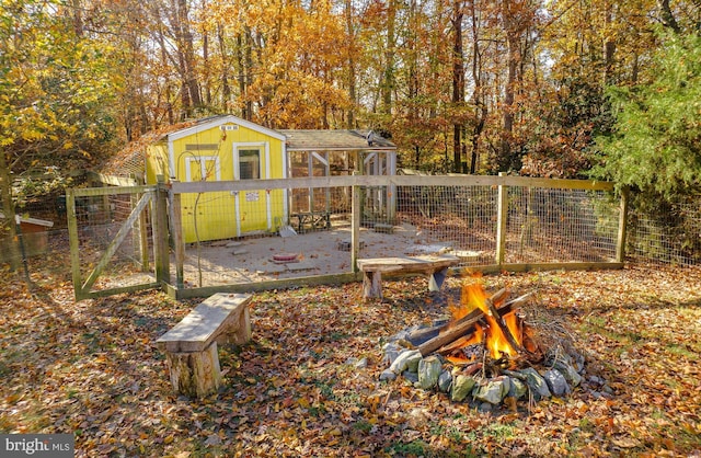 view of yard with a fire pit and an outbuilding