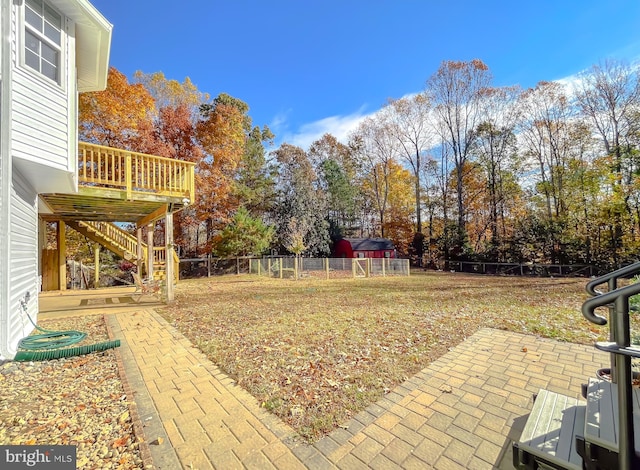 view of yard featuring a patio area and a wooden deck