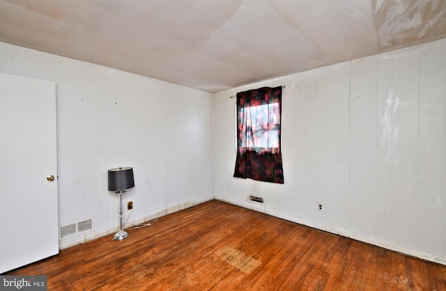 spare room featuring hardwood / wood-style flooring